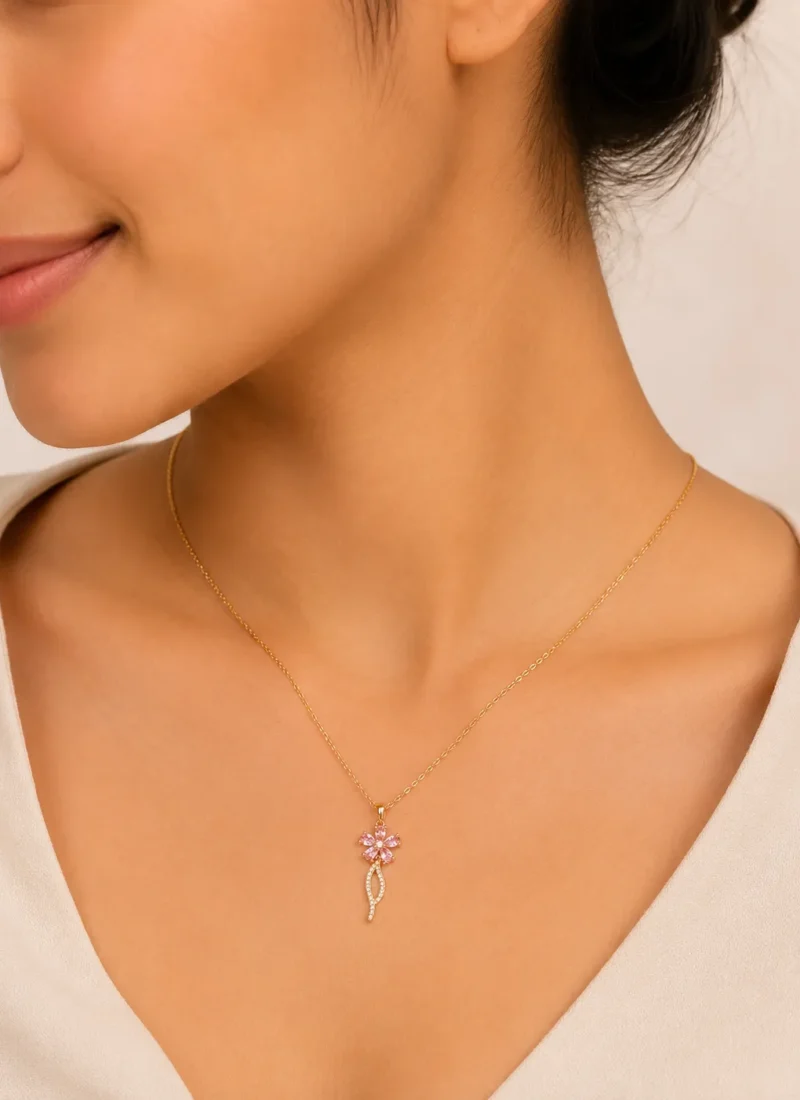 Pink Flora Spark Pendant Necklace featuring a delicate pink crystal flower pendant with gold finish