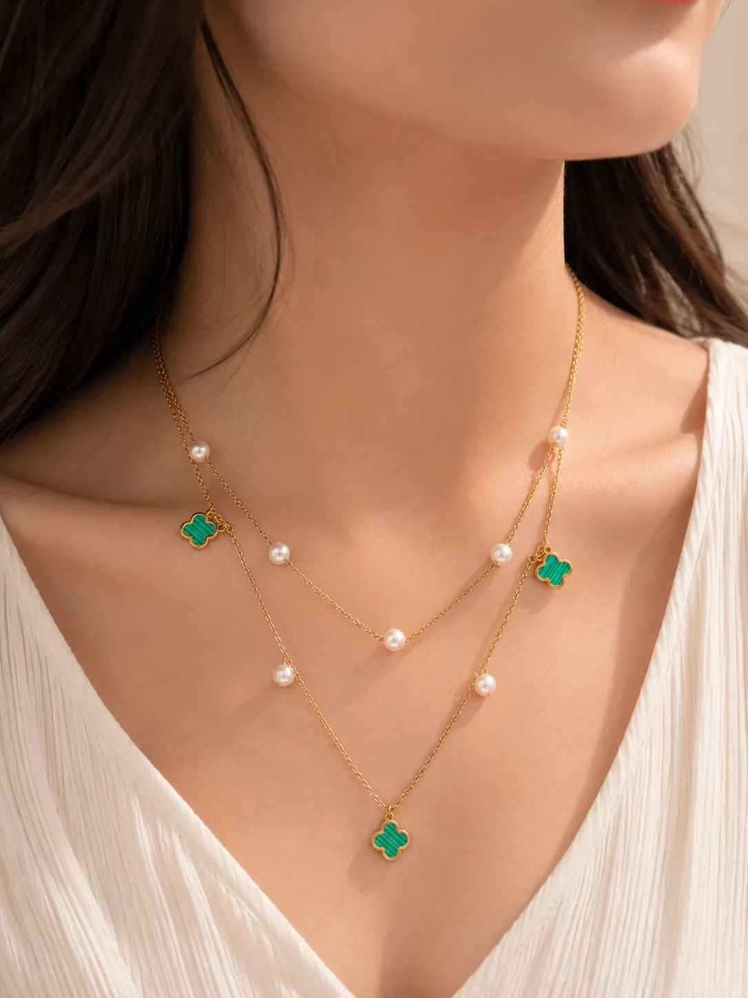 Green Double Layered Pearl Necklace Green Double Layered Pearl Necklace featuring pearl accents and emerald green clover charms on layered gold chains