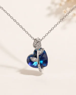 Blue Tulip Crystal Heart Pendant Necklace featuring a deep blue heart crystal in a premium silver floral design
