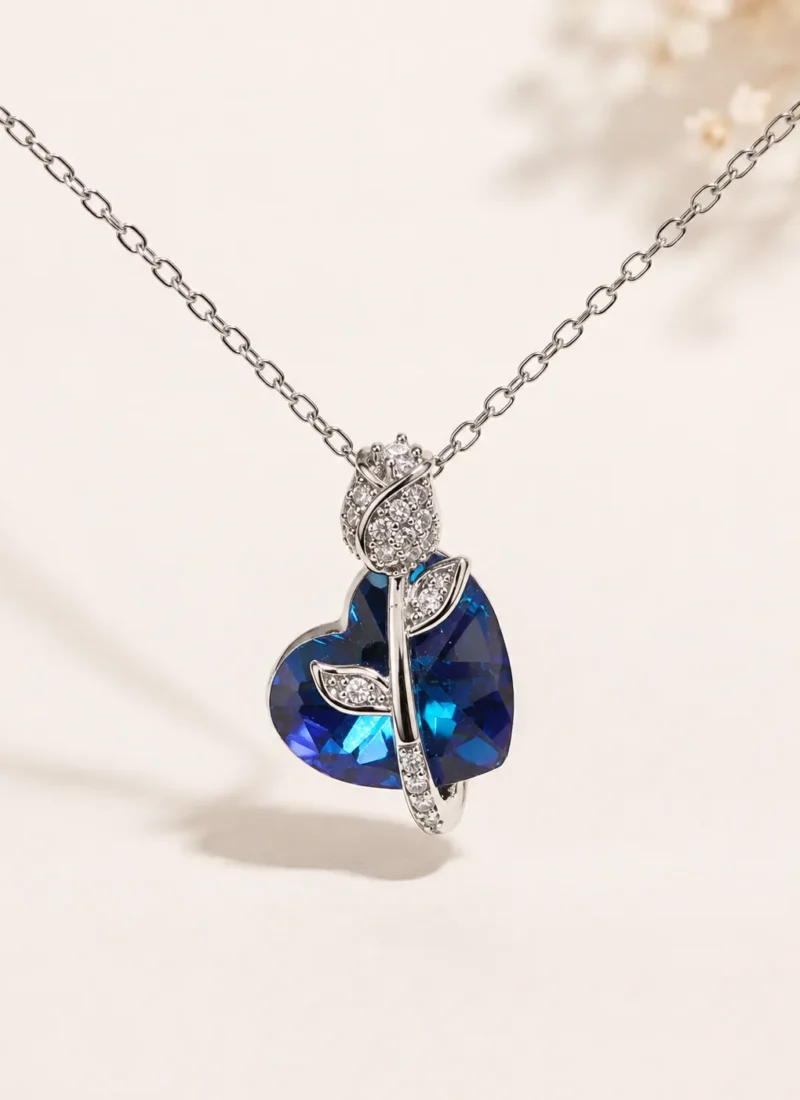 Blue Tulip Crystal Heart Pendant Necklace featuring a deep blue heart crystal in a premium silver floral design