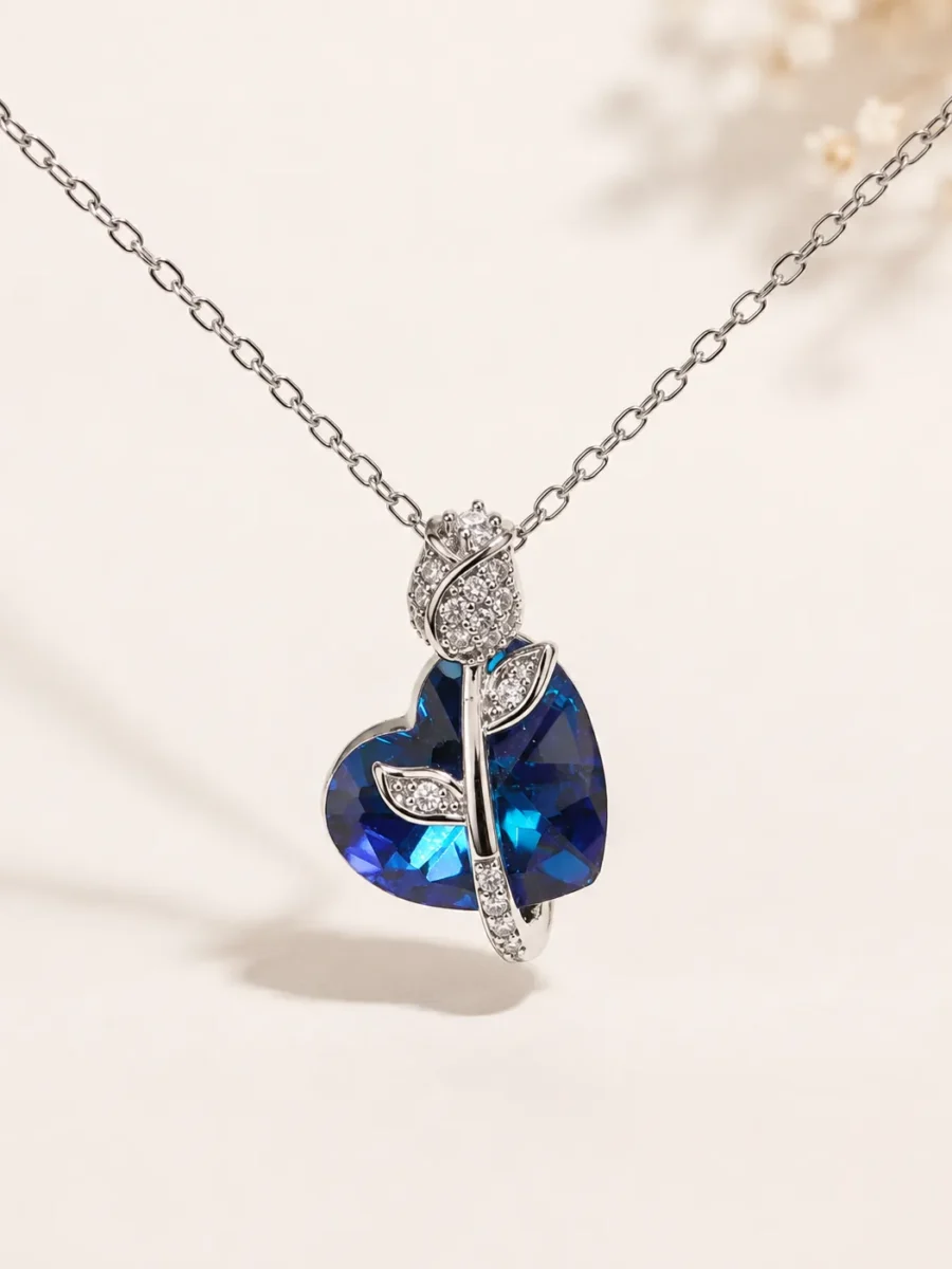 Blue Tulip Crystal Heart Pendant Necklace featuring a deep blue heart crystal in a premium silver floral design