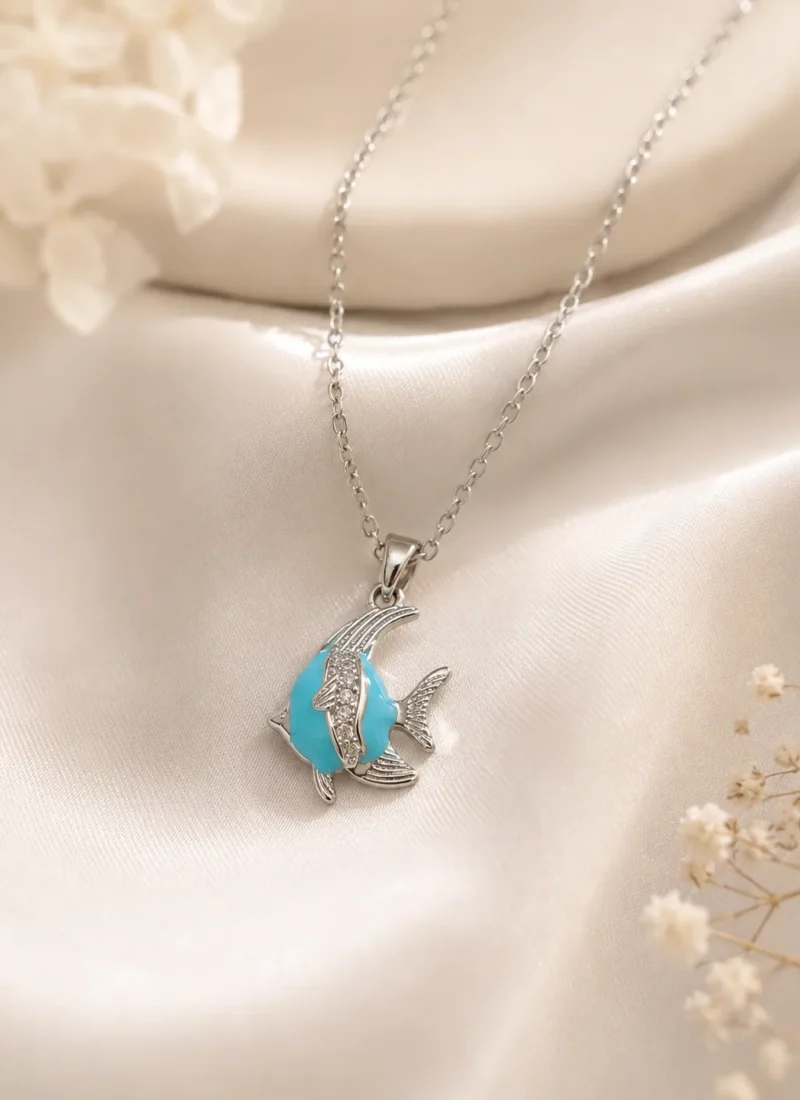 Blue Fish Pendant Necklace featuring a silver fish pendant with a turquoise-blue stone and crystal detailing