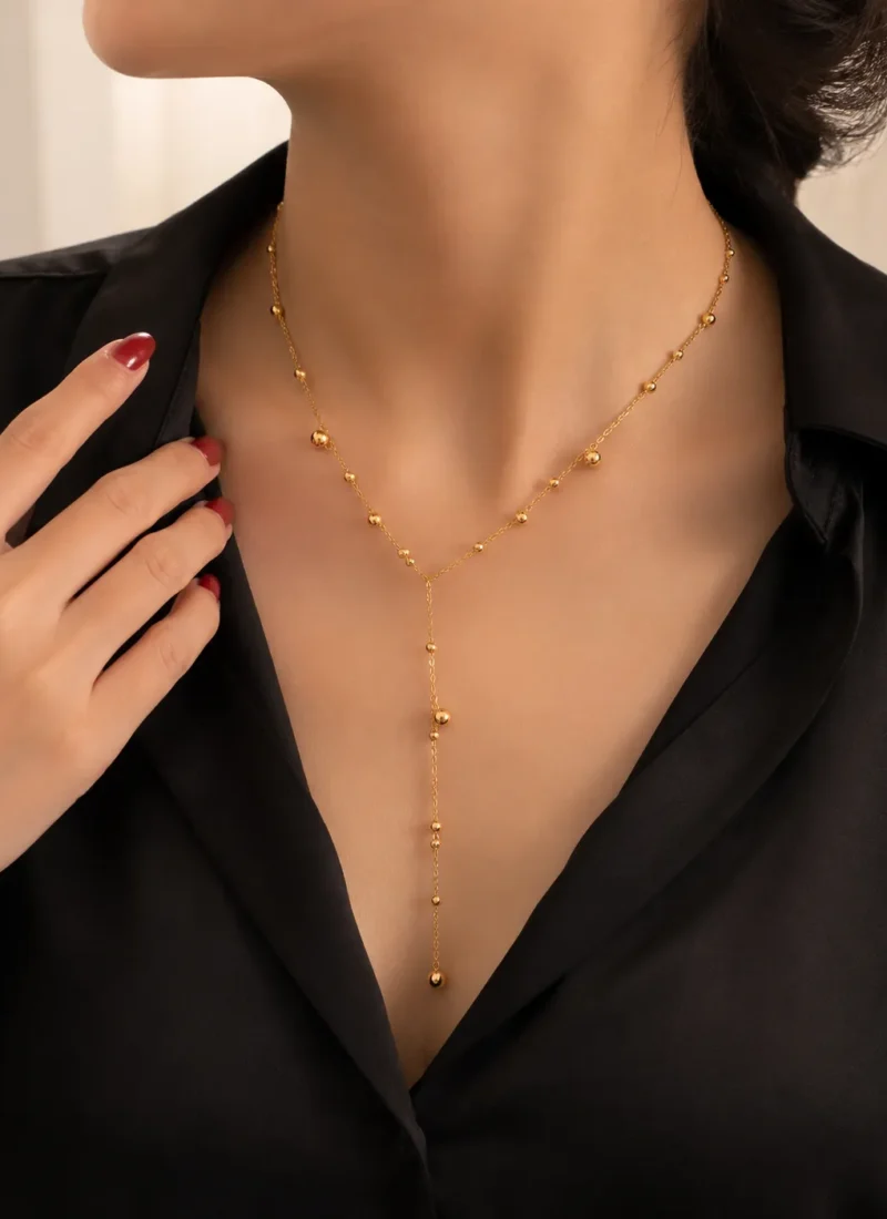 Golden Beaded Chain Necklace featuring a Y-shaped gold chain with polished bead accents