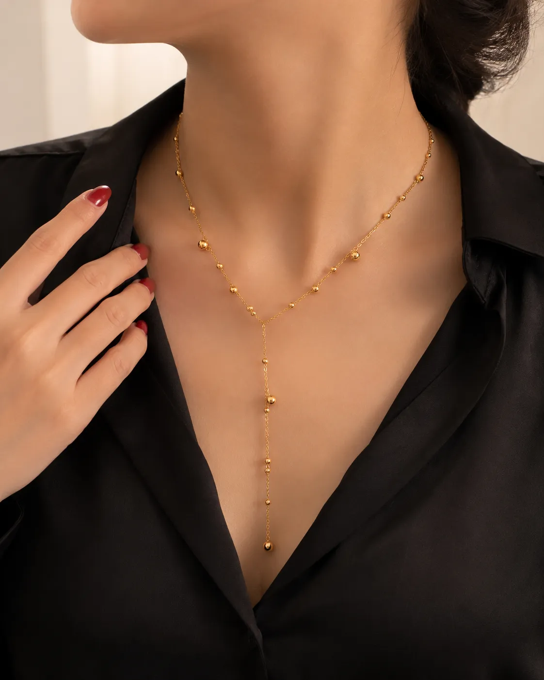 Golden Beaded Chain Necklace Golden Beaded Chain Necklace featuring a Y-shaped gold chain with polished bead accents