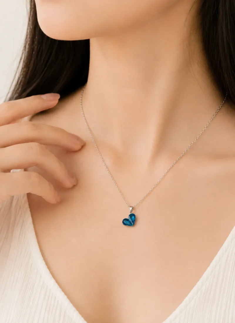 Ocean Gem Heart Pendant Necklace featuring a sparkling blue heart crystal on a premium silver chain