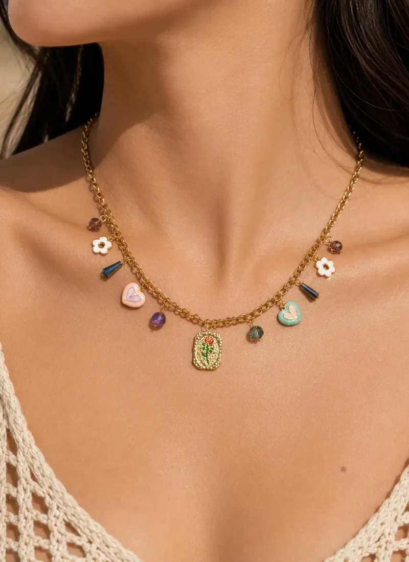 Golden Muse Charm Necklace featuring enamel hearts, floral charms, colorful crystals, and a vintage-inspired gold pendant