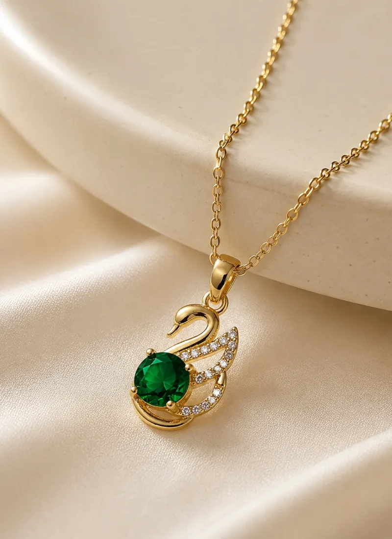 Emerald Swan Pendant Necklace featuring a green crystal and sparkling zirconia accents in a premium gold finish