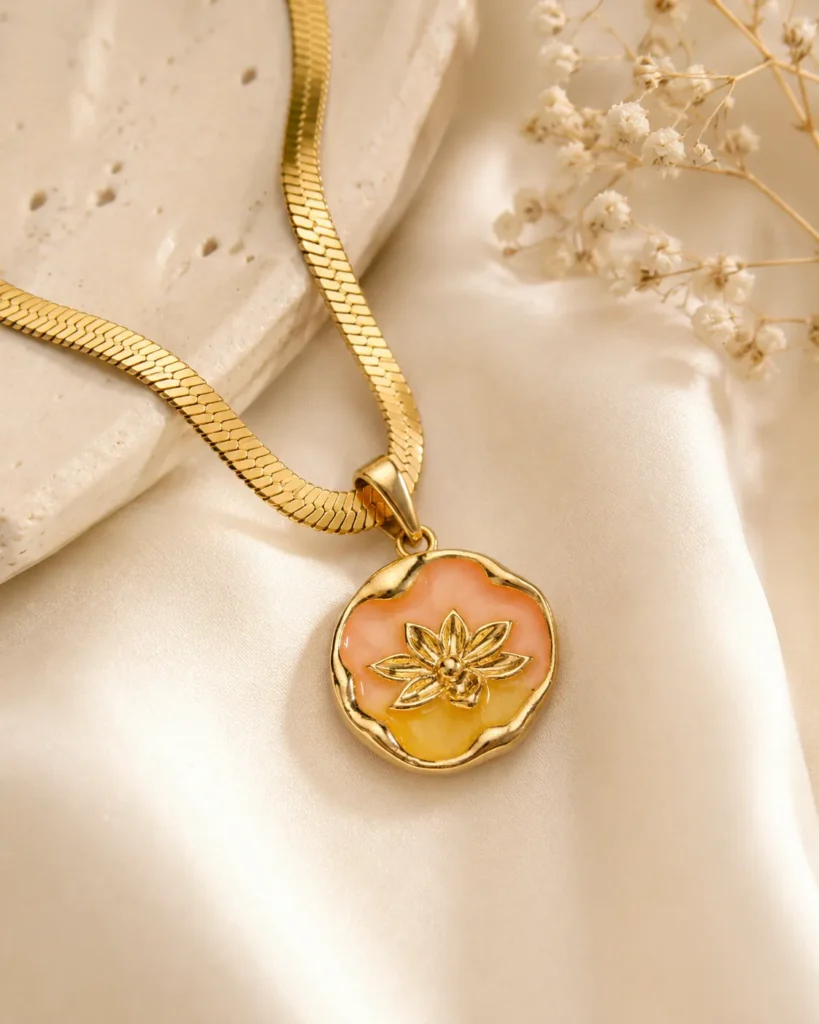 Peach Blossom Necklace featuring a peach and golden floral enamel pendant with a premium gold finish