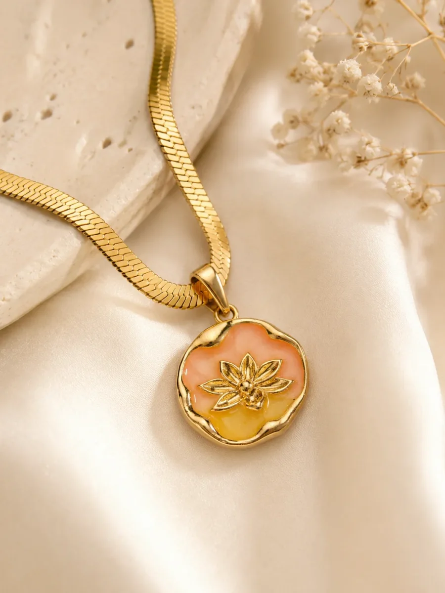 Peach Blossom Necklace featuring a peach and golden floral enamel pendant with a premium gold finish