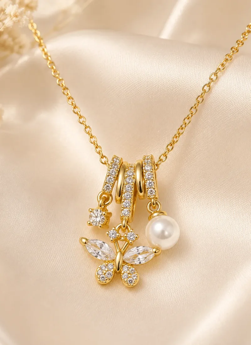 Golden Butterfly Crystal Necklace featuring sparkling butterfly crystals, pearl charm, and gold finish