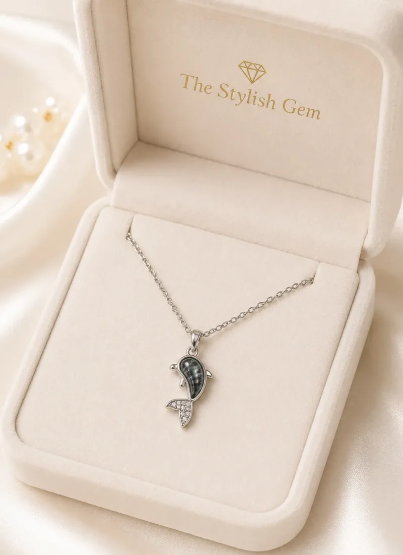 Dolphin Pendant Necklace featuring a silver dolphin pendant with marbled grey stone and crystal detailing
