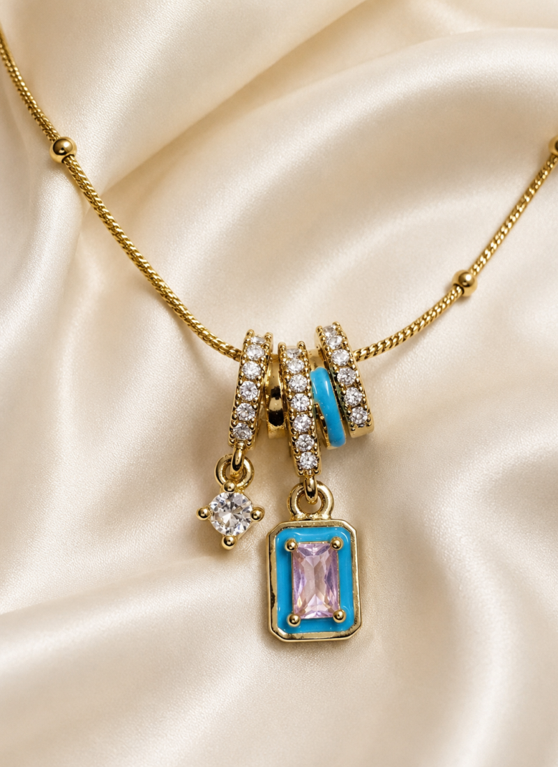 Blue Pink Crystal Charm Pendant Necklace featuring blush pink crystal, turquoise enamel accents, and sparkling white crystal charms