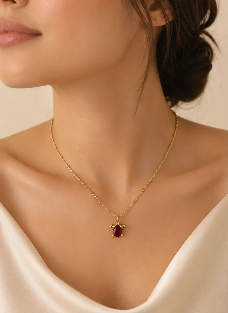 Ruby Turtle Pendant Necklace featuring a brilliant ruby-red crystal in a premium gold turtle design