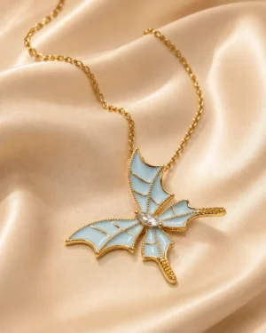 Sky Butterfly Pendant Necklace featuring blue enamel butterfly wings with a sparkling crystal center in a premium gold finish