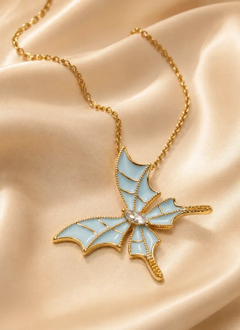 Sky Butterfly Pendant Necklace featuring blue enamel butterfly wings with a sparkling crystal center in a premium gold finish