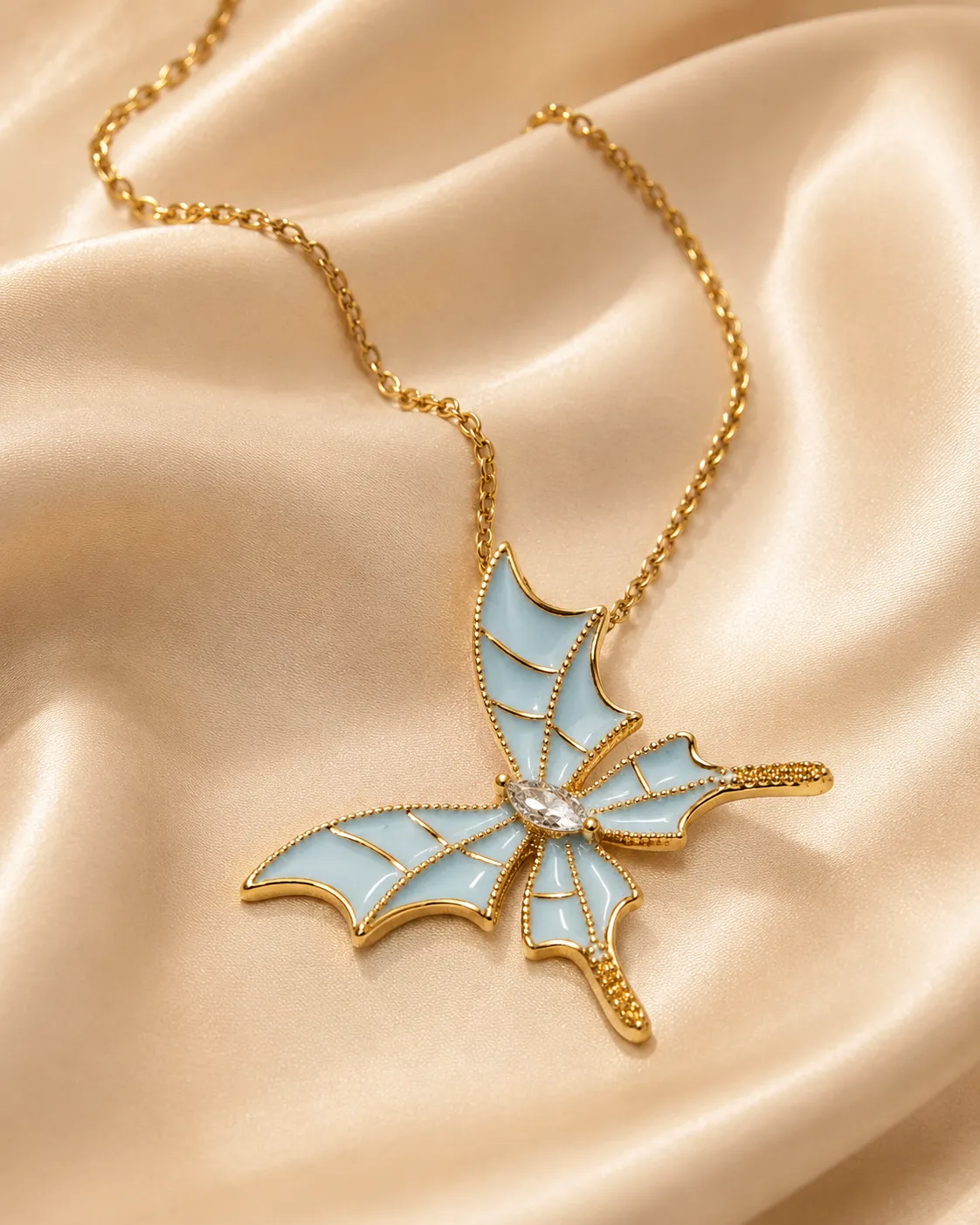 Sky Butterfly Pendant Necklace Sky Butterfly Pendant Necklace featuring blue enamel butterfly wings with a sparkling crystal center in a premium gold finish