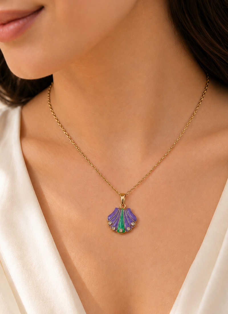 Purple Tide Necklace featuring a purple and emerald shell pendant with sparkling crystal accents in a gold finish