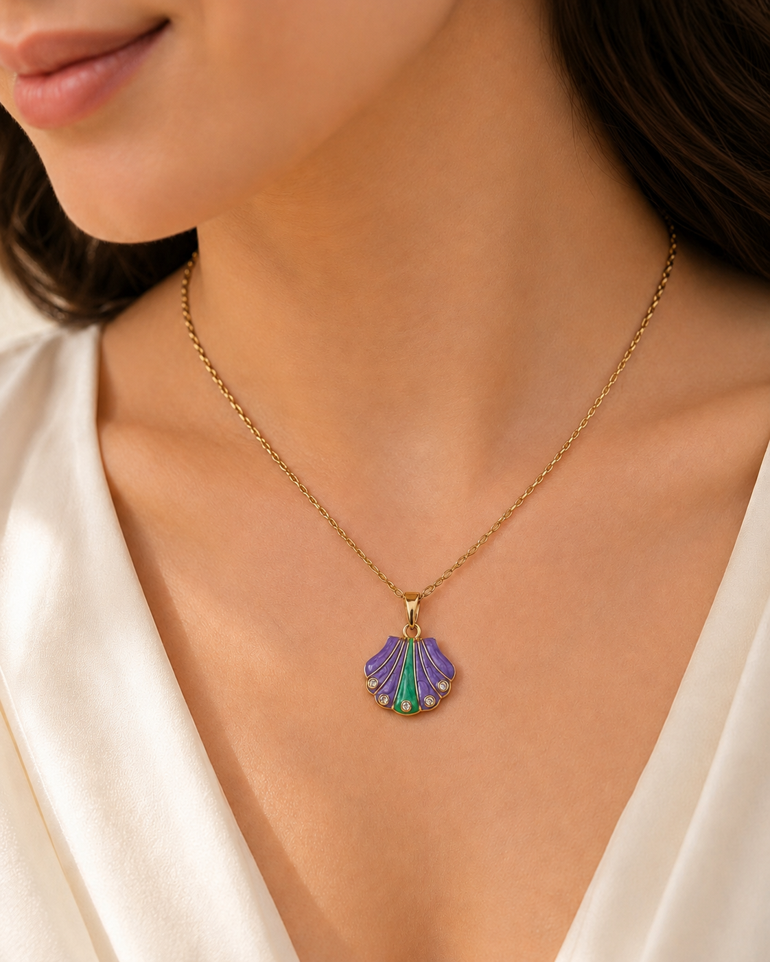 Purple Tide Necklace Purple Tide Necklace featuring a purple and emerald shell pendant with sparkling crystal accents in a gold finish