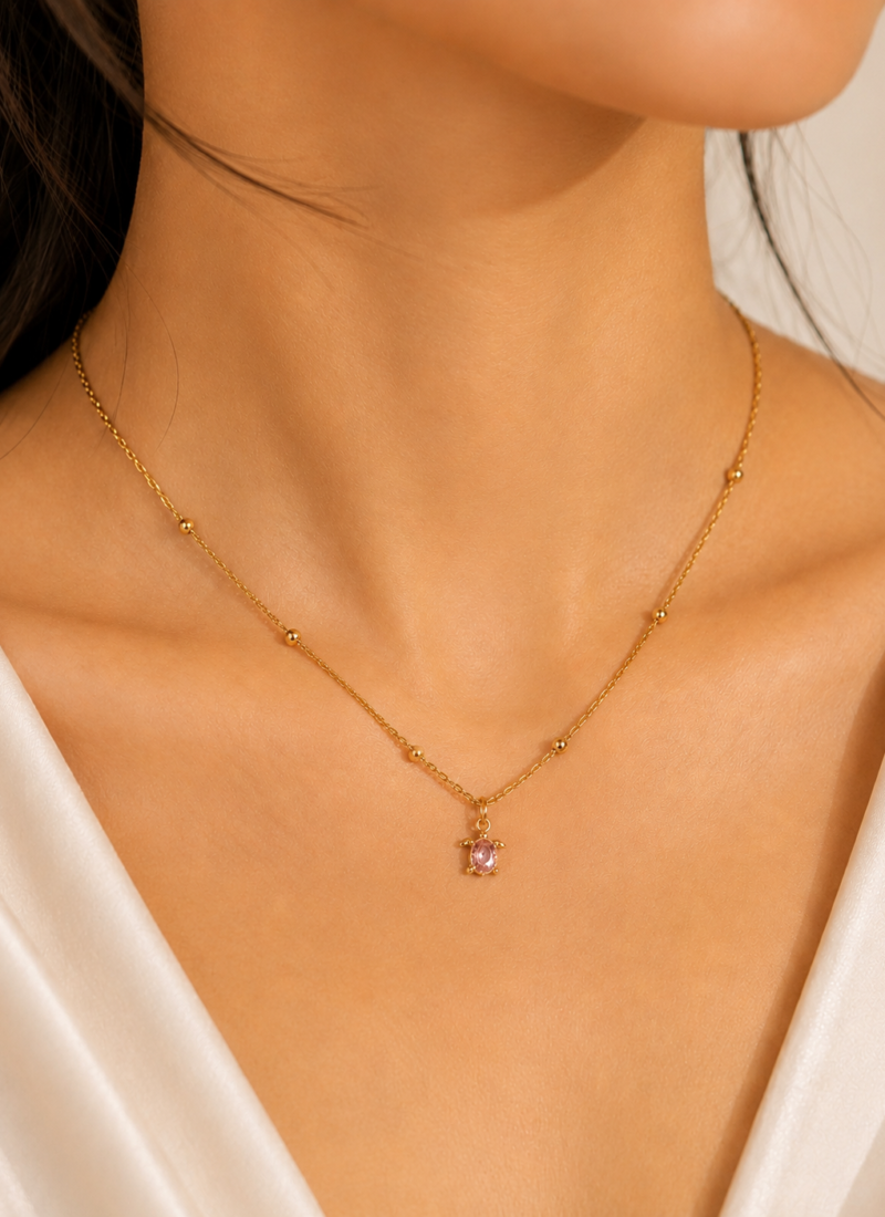 Blush Turtle Pendant Necklace featuring a sparkling pink crystal set in a premium gold turtle pendant
