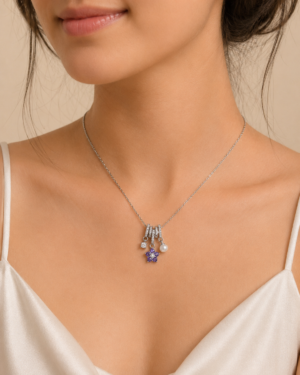 Purple Minimal Charm Pendant Necklace featuring a purple crystal flower, pearl, and silver charm design