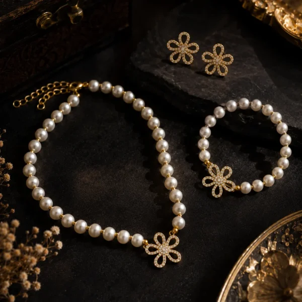 Flora Pearl Jewellery Set featuring pearl necklace, pearl bracelet, and crystal floral earrings in gold finish