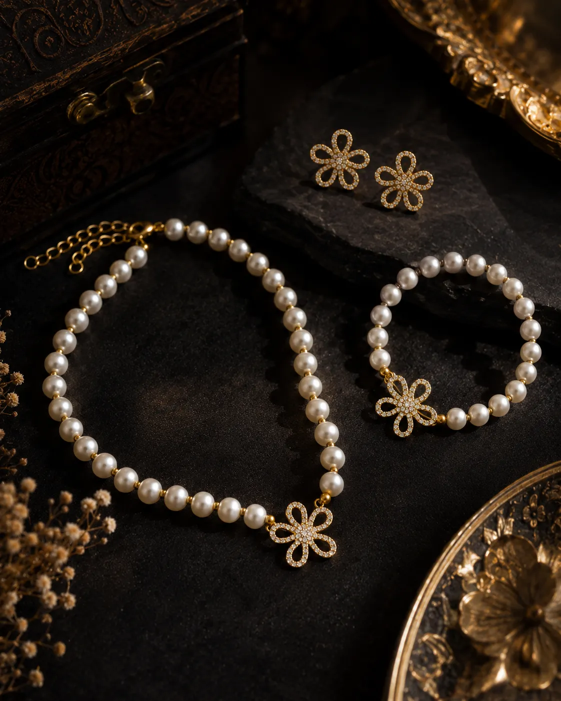 Flora Pearl Jewellery Set Flora Pearl Jewellery Set featuring pearl necklace, pearl bracelet, and crystal floral earrings in gold finish