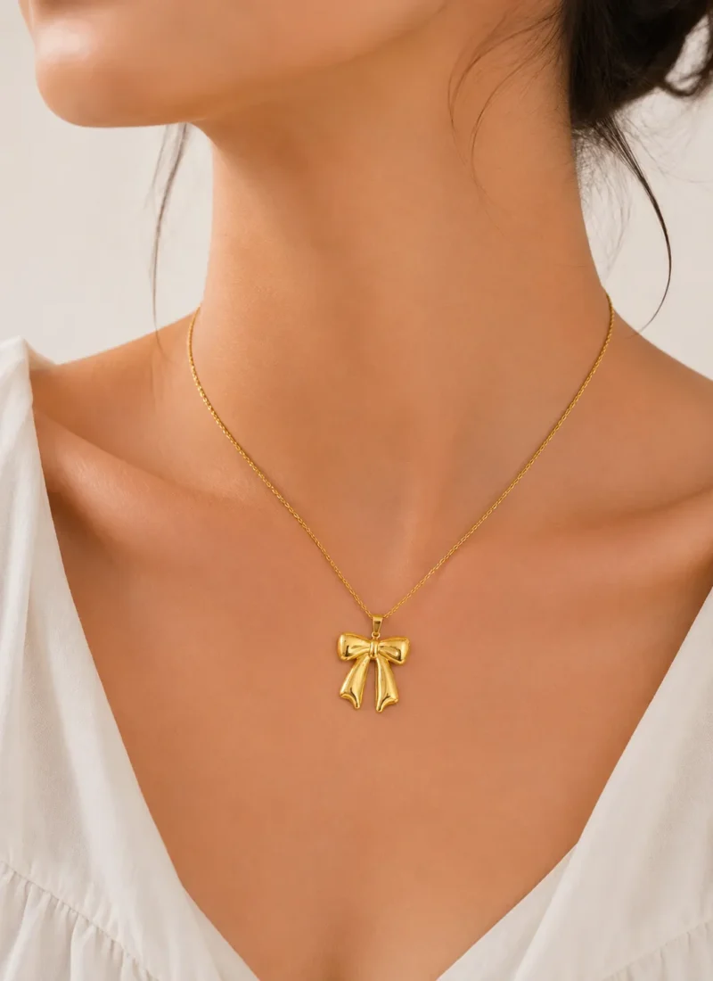 Golden bow pendant necklace close-up